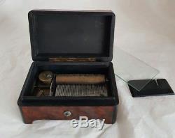 A French late C19th cylindrical music box. Veneered in Burr Amboyna & Ebany